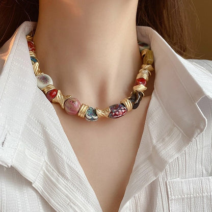Handcrafted Ceramic Bead Necklace – Artistic Gold Twist Statement